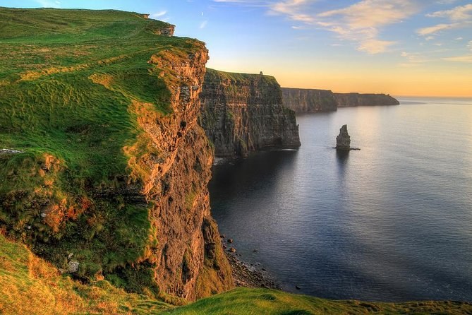 The Cliffs of Moher in low evening light, the stack offshore