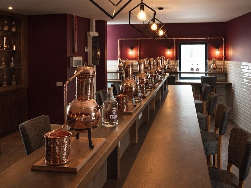 Copper stills and glasses set out along a tasting counter