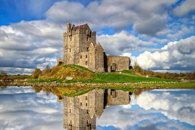 Dunguaire Castle reflected in still water at Kinvara