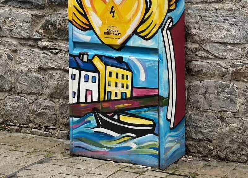 A painted utility box in Galway showing a hooker under sail