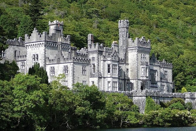 The front of Kylemore Abbey among the trees
