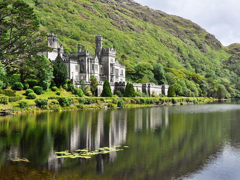 Kylemore Abbey reflected in the lake beneath the mountain