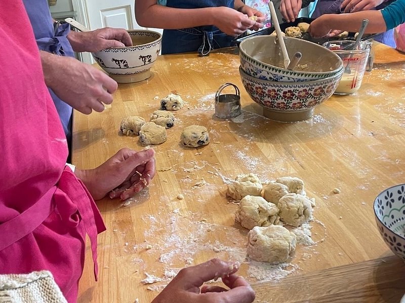 Hands shaping dough on a floured table